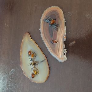 Iron and amber dragonflies on polished stone slices